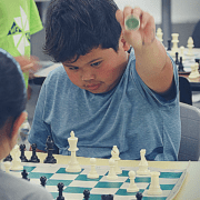 YEL chess student prepares to capture the piece from his opponent.