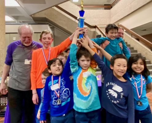 Chess kids compete in non-elimination tournaments. This team won first place at a local tournament.