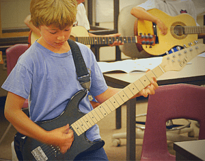 A young guitarist with an electric guitar.