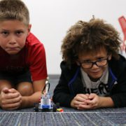 Two Brick Builder students prepare to race their car made out of LEGO Bricks.