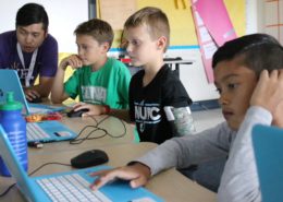 Coding instructor leads students on how to write computer code.