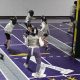 Fencing club with fencers fencing.