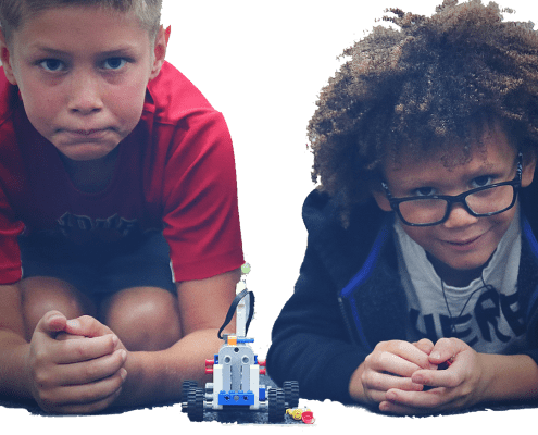 Two boys ready to race a brick car.